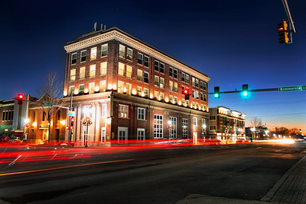 A captivating night scene of a street in Emporia, KS, with light trails and illuminated buildings.