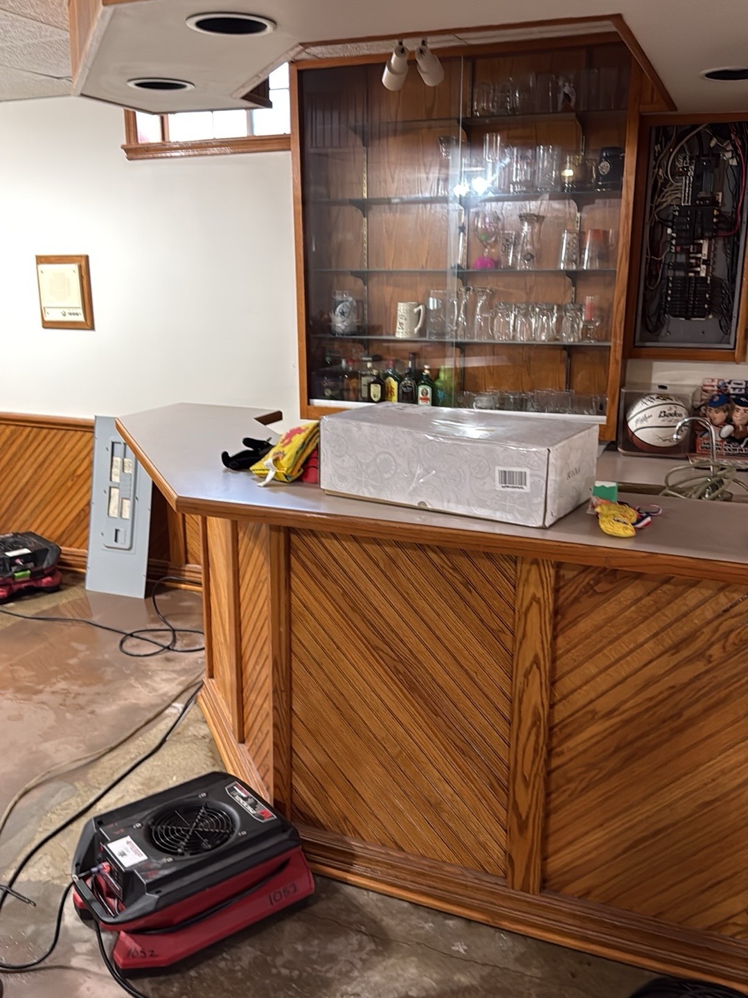Air mover beside a basement bar during water damage restoration in Gleneagles, Wichita